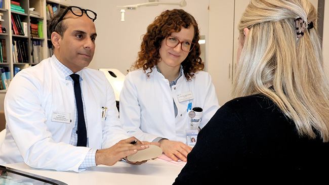 Prof. Dr. Afshin Rahmanian-Schwarz, Chefarzt Klinik Plastische und Ästhetische Chirurgie, und Oberärztin Dr. Johanna Schwarz beraten eine Patientin über die Möglichkeiten des Brustwiederaufbaus.